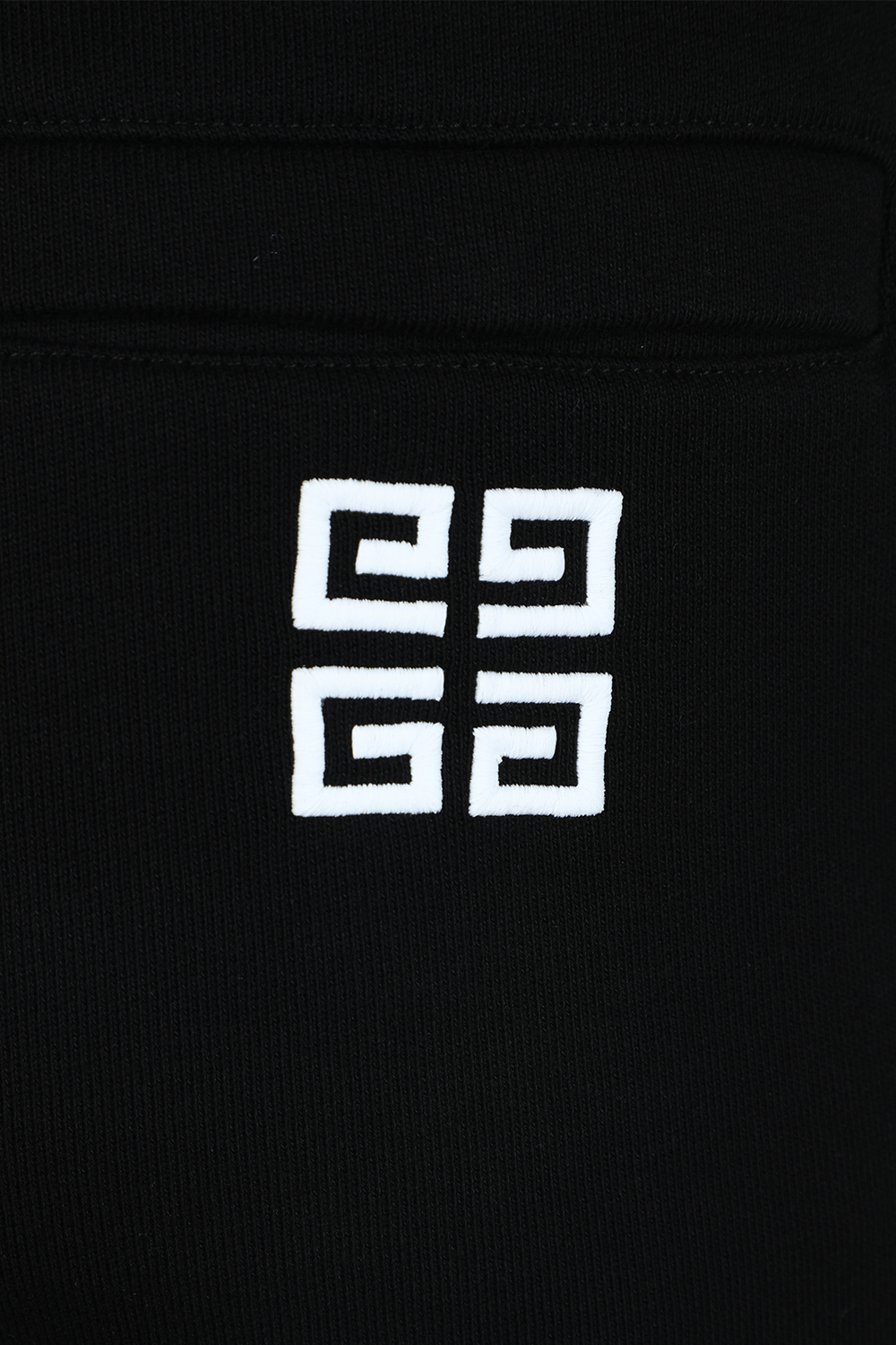 תמונת תקריב של מכנסי סלים ג'וג שחורים עם לוגו GIVENCHY